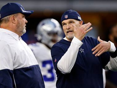 Dallas Cowboys head coach Mike McCarthy (left) listens to his defensive coordinator Dan Quinn during pregame warmups at AT&T Stadium in Arlington, Monday, September 27, 2021.
