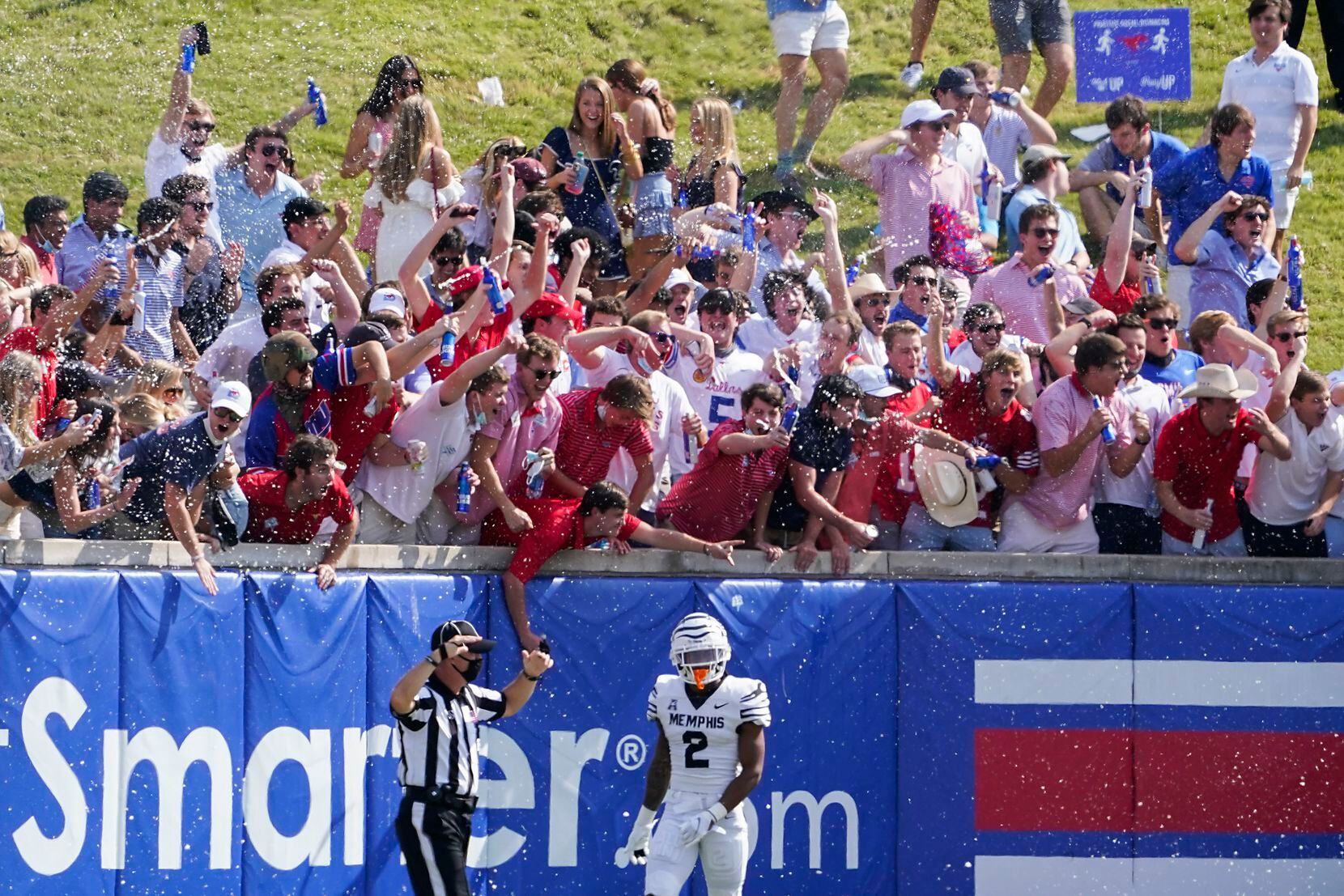 SMU fans in the student section on the hill cheer after a touchdown by wide receiver Reggie Roberson Jr. as Memphis defensive back T.J. Carter (2) turns away during the first half of a game at Ford Stadium on Saturday, Oct. 3, 2020, in Dallas.