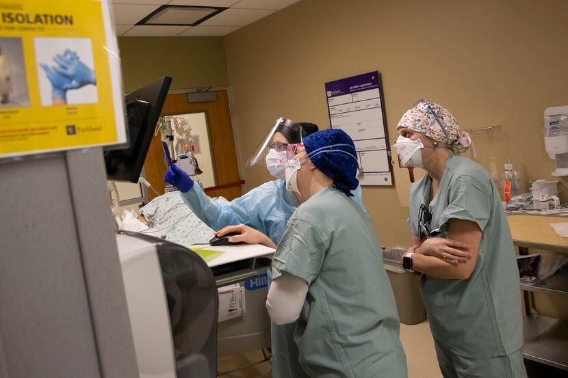 From left: Nurses Kelsey O’Meara, Noelle Hackfeld and Joanna Pless review an intubated...