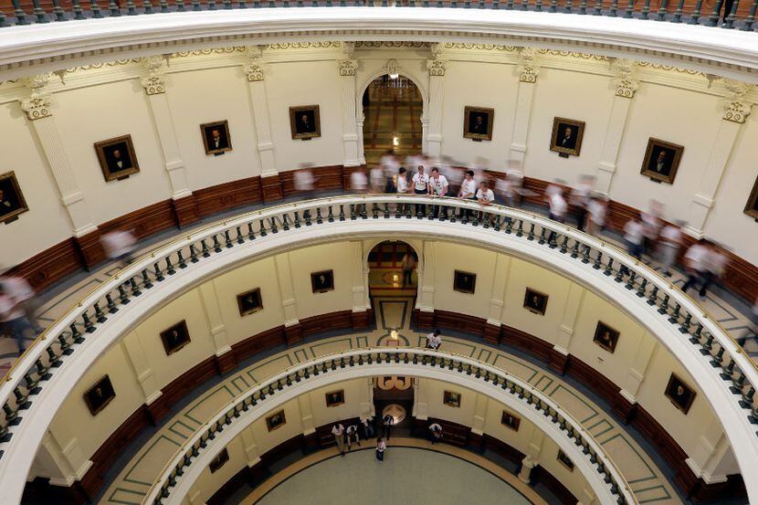 Visitors move though the rotunda at the Texas Capitol, Thursday, June 15, 2017, in Austin,...