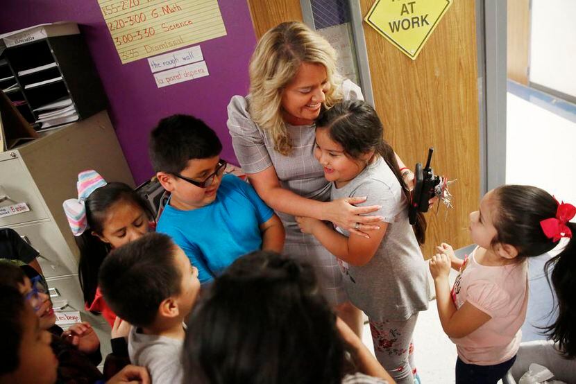 Aaliyah Miranda hugged with some of her students at Seguin Elementary in Grand Prairie,...