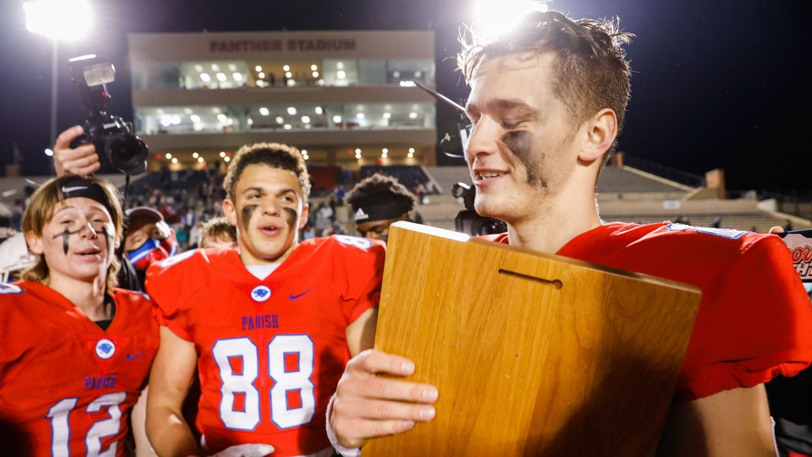 Quarterback Preston Stone holds the plaque after Parish Episcopal won the TAPPS Division I...