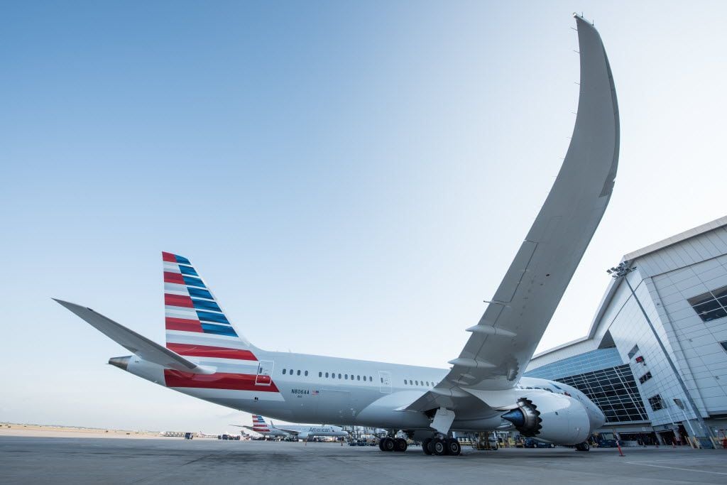 An American Airlines jet sits at a loading gate at Dallas/Fort Worth International Airport.