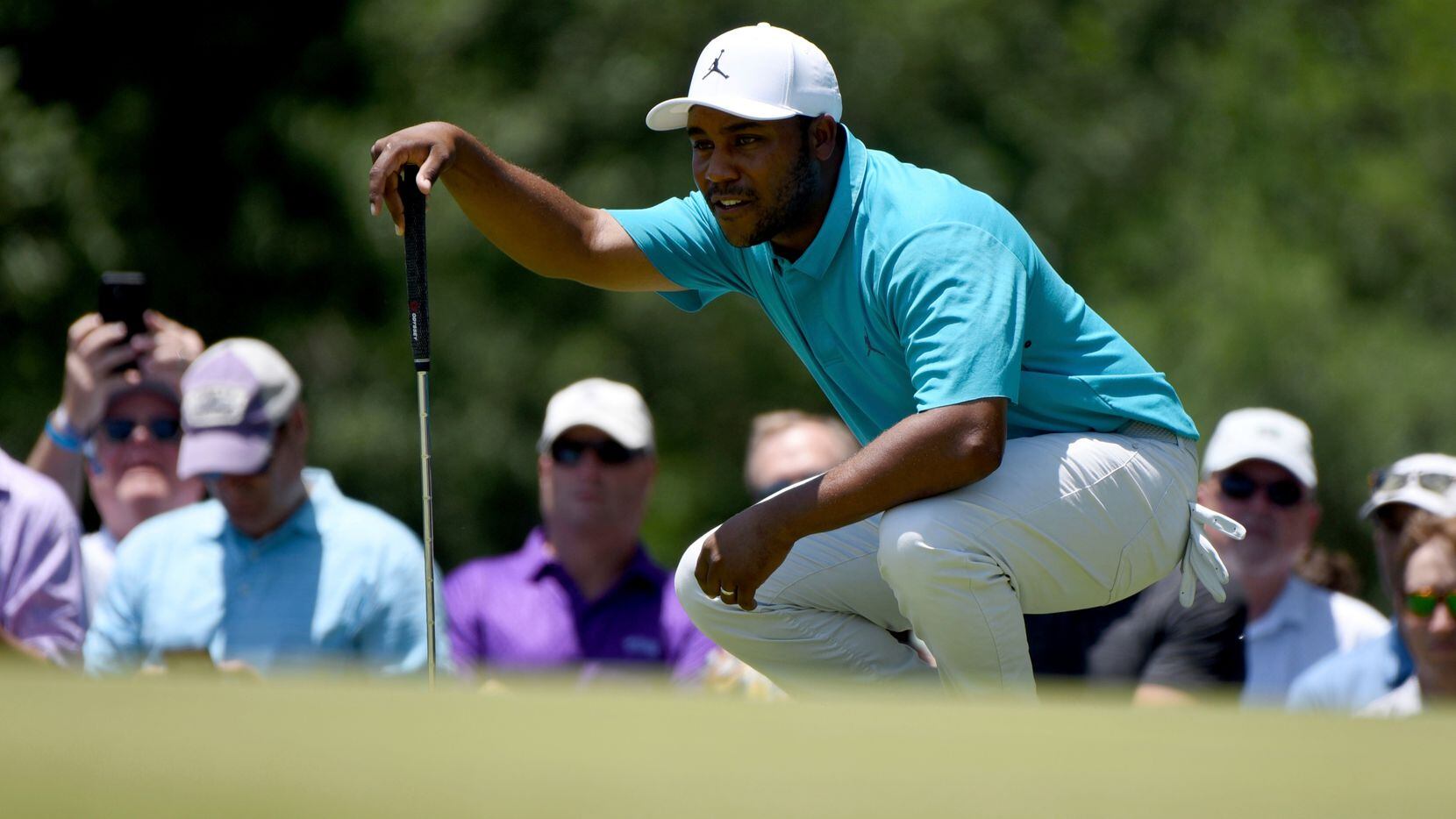 Harold Varner III prepares to putt on the second green during the third round of the Charles...