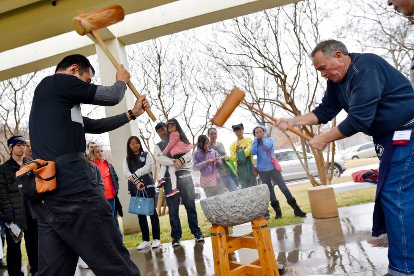 Naoki Hariyama (left) and Mark Berry perform a rice pounding called mochitsuki during the...