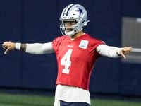 Dallas Cowboys quarterback Dak Prescott stretches during practice at The Star in Frisco,...