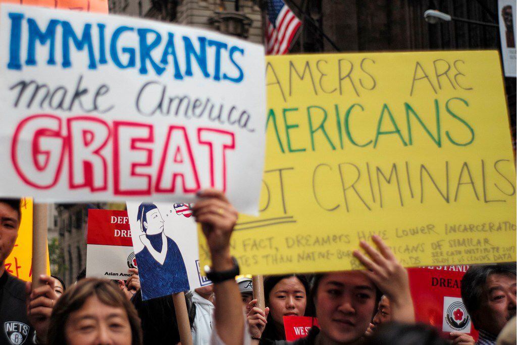 Protesters hold up signs during a demonstration against U.S. President Donald Trump during a rally in support of the Deferred Action for Childhood Arrivals (DACA), also known as the Dream Act, near Trump Tower in New York on Oct. 5, 2017.