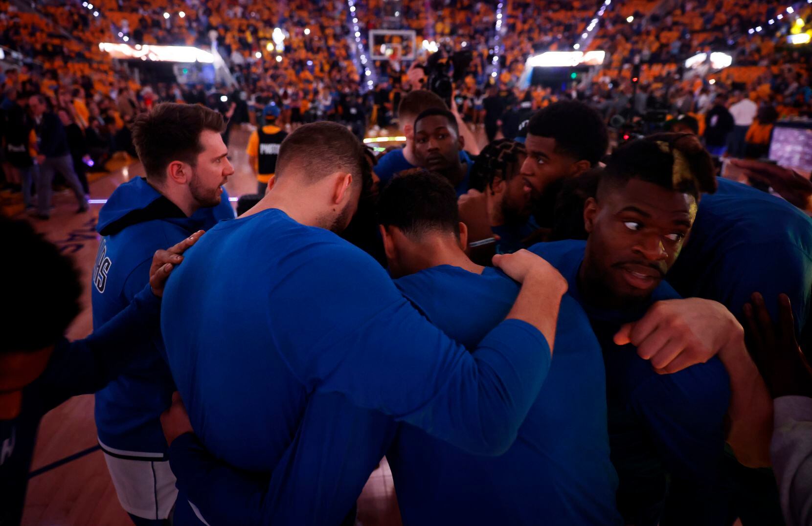 The Dallas Mavericks huddle on the floor before facing the Golden State Warriors in Game 5...