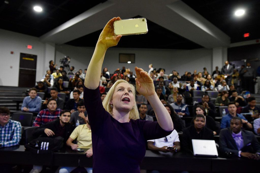 Senator Kirsten Gillibrand holds her phone as she takes a selfie video with students from...