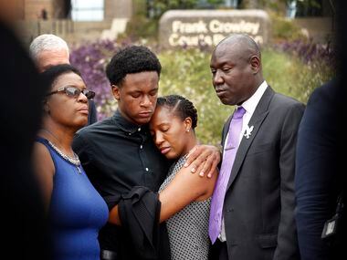 Brandt Jean, brother of shooting victim Botham Jean (second from left), hugs his sister...