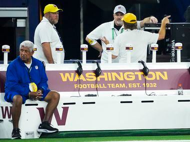 Officials gather around The Washington Football Team bench before an NFL football game...