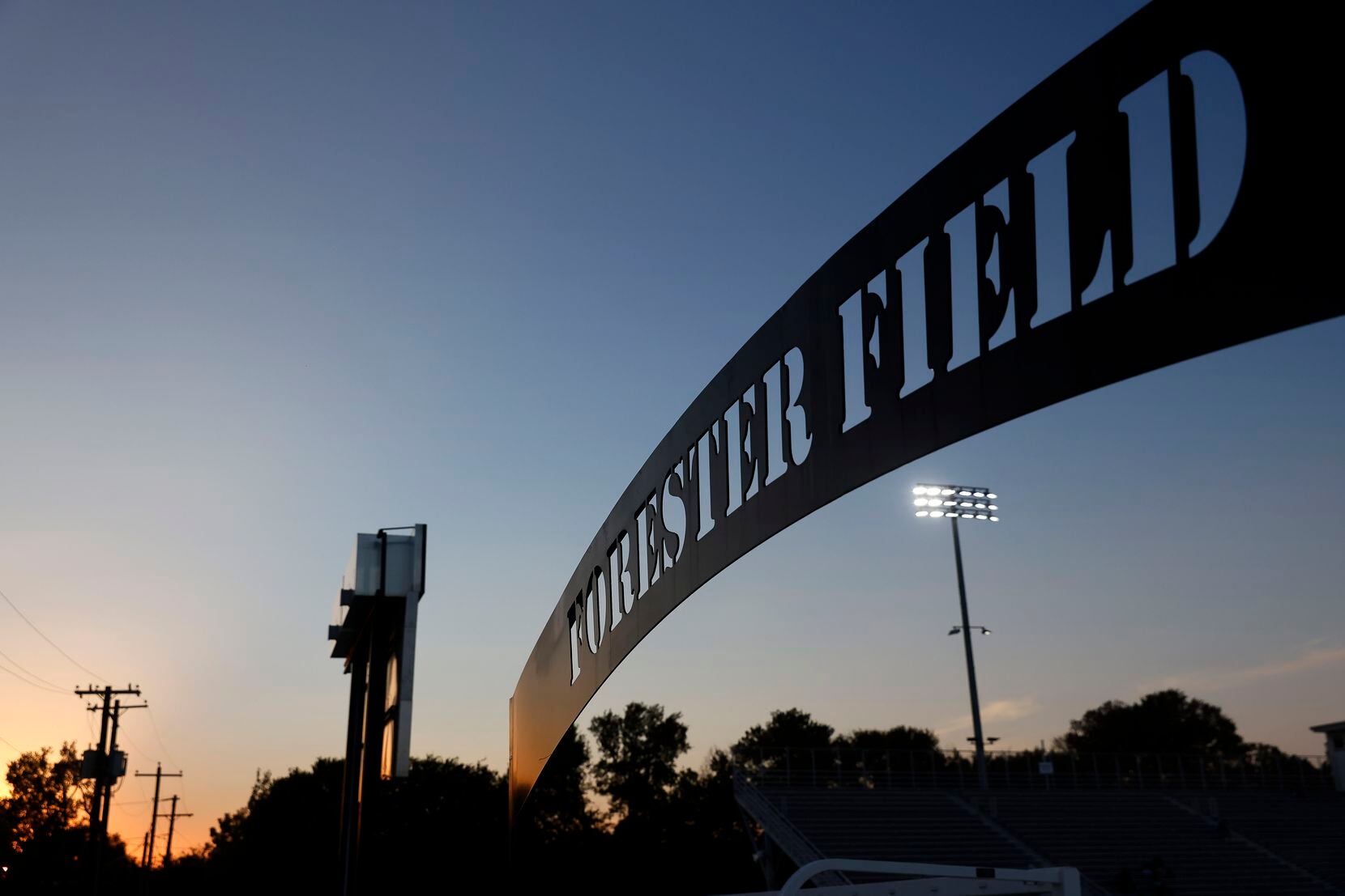 The sun sets at Forester Field in Dallas, October 6, 2022 before the W.T. White-Bryan Adams...