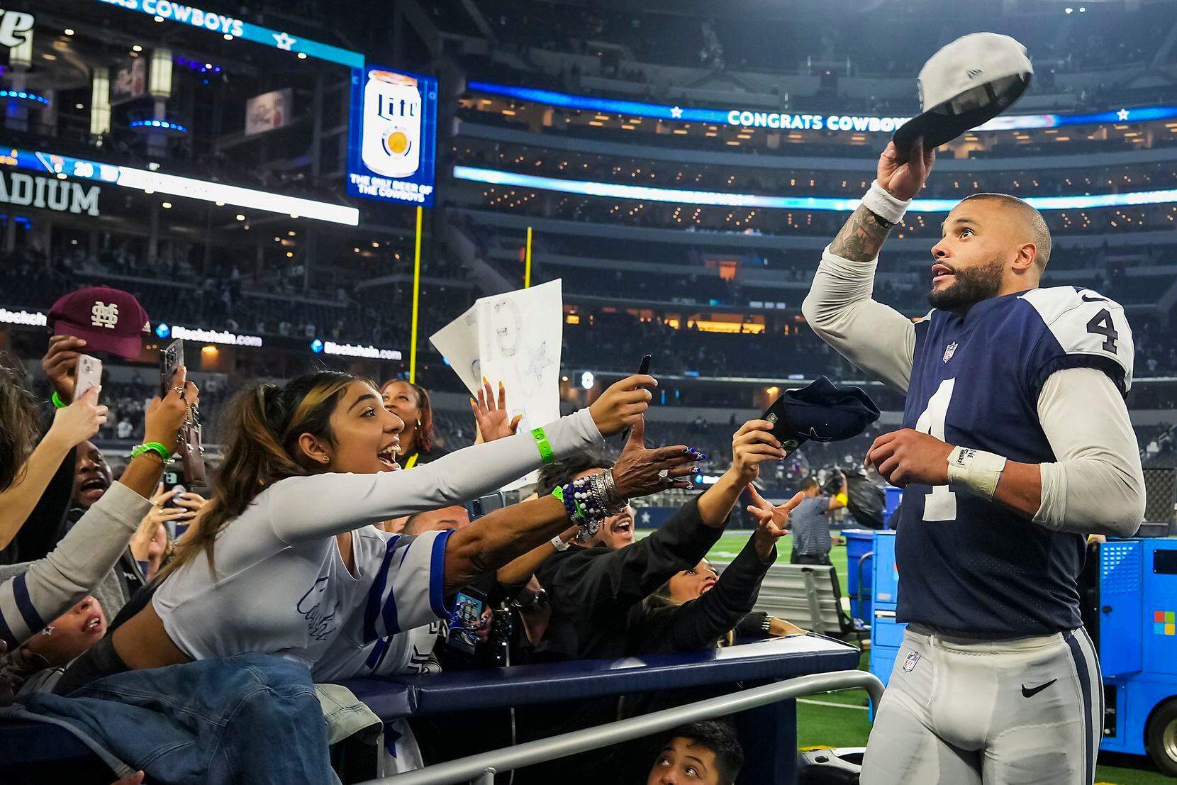 Dallas Cowboys quarterback Dak Prescott tosses his cap to the crowd after a 28-20 victory...