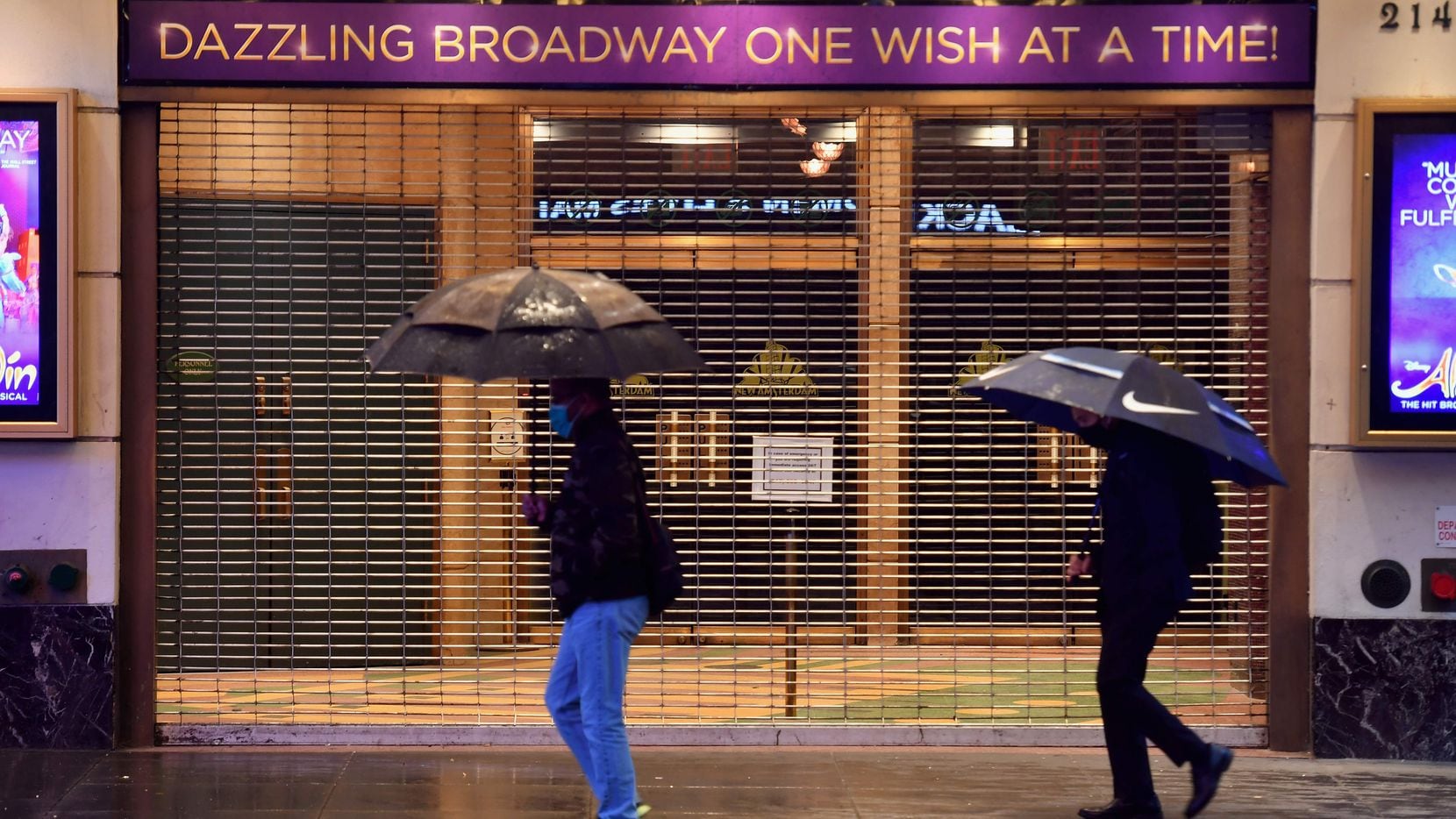 People walk past a closed Broadway theater near Times Square on Oct. 12, 2020 in New York City.