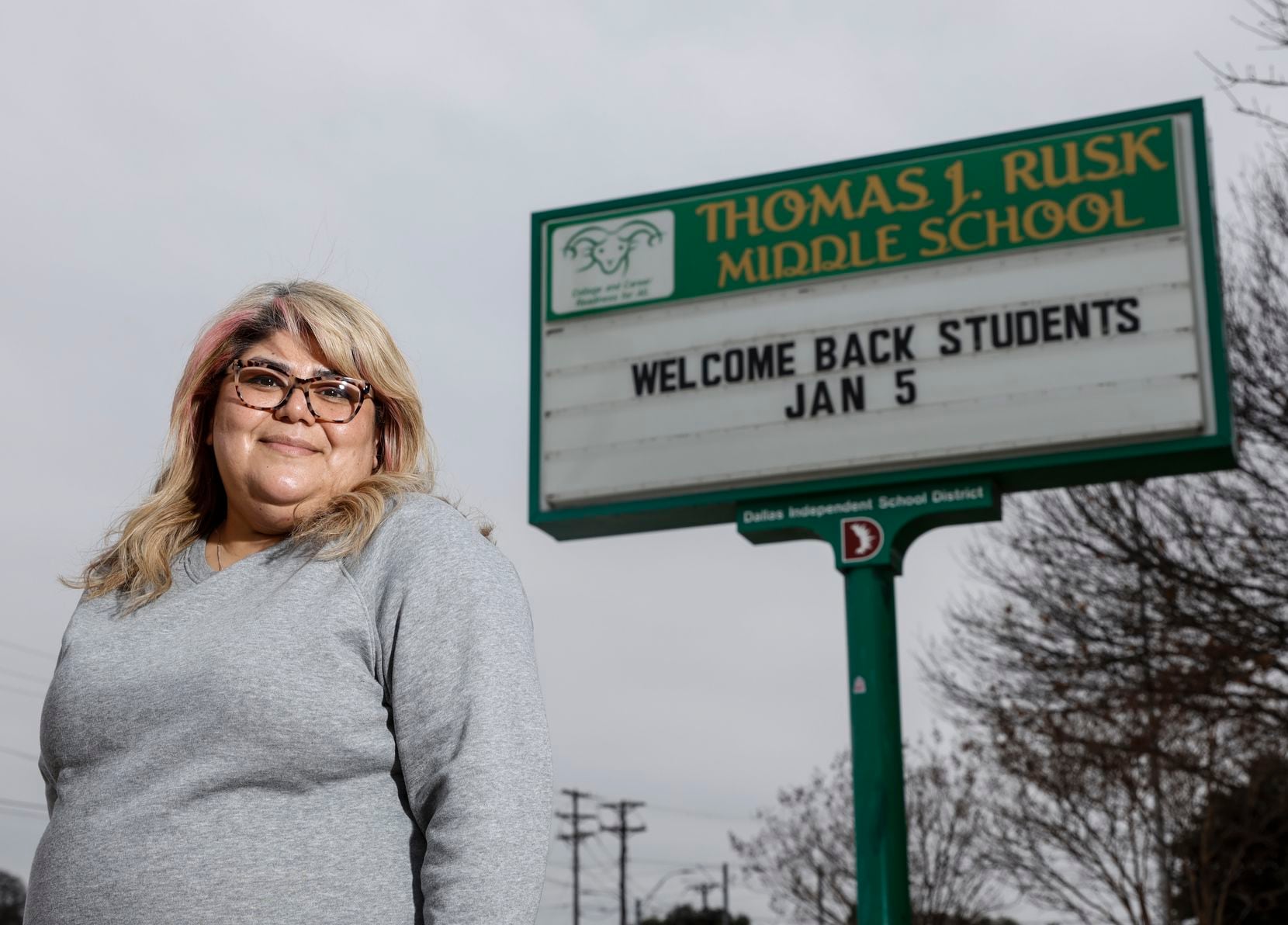 Sandra Roman, a parent of an eighth grader at Thomas J. Rusk Middle School, stood in front of the school in Dallas on Jan. 7, 2022.