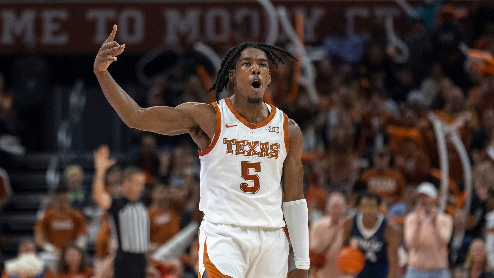 Texas guard Marcus Carr celebrates a three-point shot against Rice during the first half of...
