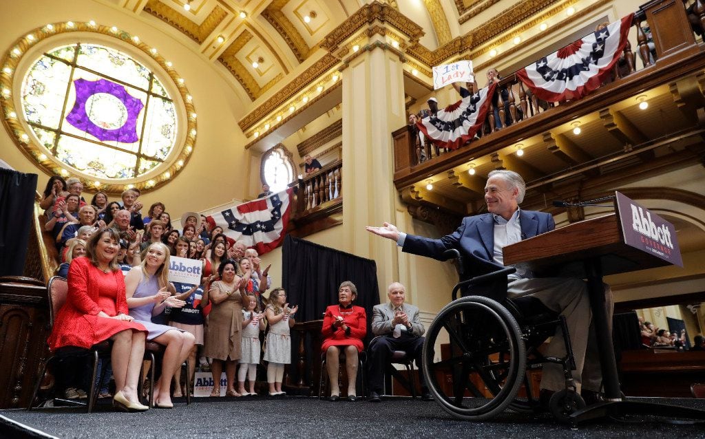 Texas Gov. Greg Abbott, right, points to his wife Cecilia, left, and daughter, Audrey,...