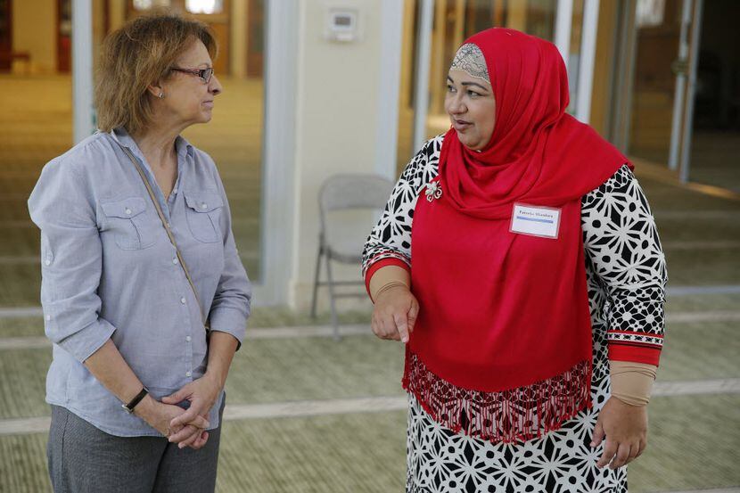 Phyllis Mabbitt (left), of Plano, Texas, listens to tour guide Fareeha Miandara while inside...