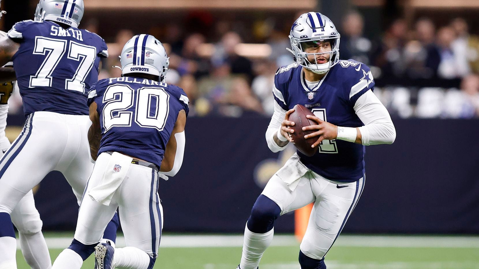 Dallas Cowboys quarterback Dak Prescott (4) fakes the handoff to running back Tony Pollard (20), rolling out of the pocket against the New Orleans Saints at the Caesars Superdome in New Orleans, Louisiana December 2, 2021.