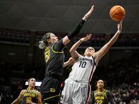 UConn's Nika Muhl (10) shoots as Baylor's Caitlin Bickle (51) defends in the first half of a...