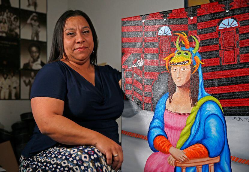 Artist Katherine Rodriguez, with one of her paintings at Sara Rosado's home in Arlington,...