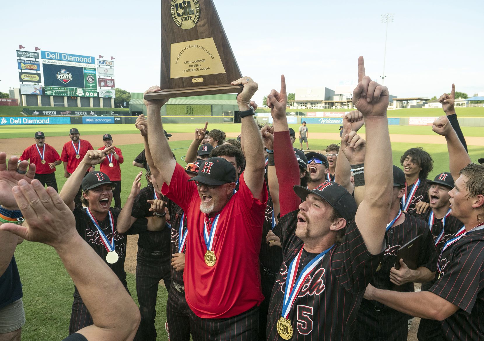 Rockwall-Heath head coach, Greg Harvey and the team celebrate with the championship trophy after defeating Keller in the 2021 UIL 6A state baseball final held, Saturday, June 12, 2021, in Round Rock, Texas.  Rockwall-Heath defeated Keller 4-3.   (Rodolfo Gonzalez/Special Contributor) 
