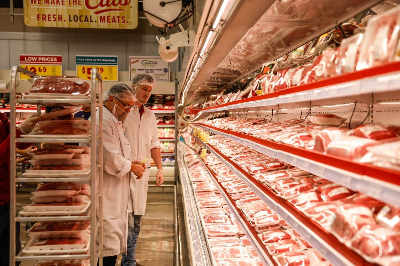 H-E-B worker checks the meats section at the new store that opened its door to public at 6AM...