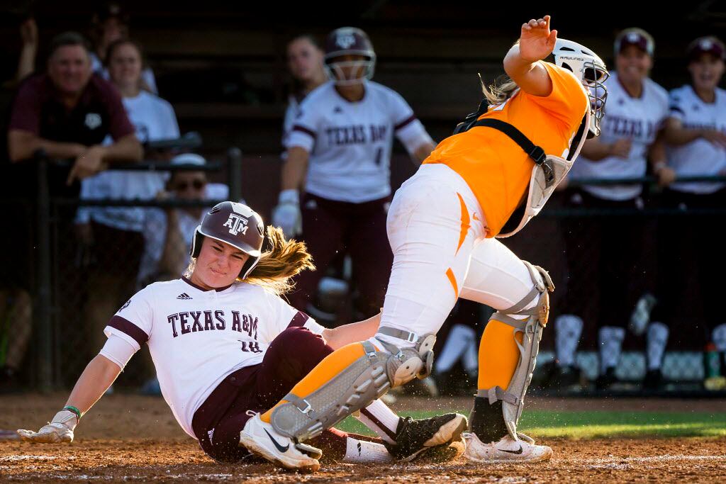 Texas A&M outfielder Sarah Hudek is out at home trying to score past Tennessee catcher Abby...