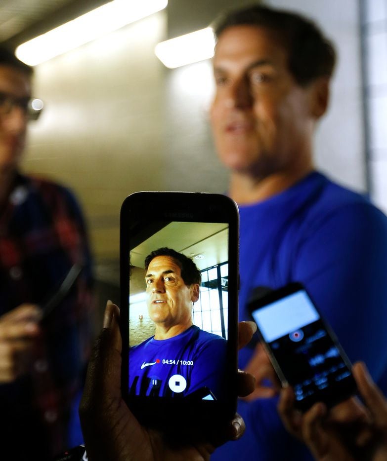 A member of the media uses a cell phone to record a video of Mark Cuban in an interview...