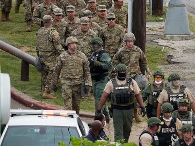 National Guard troops and DPS troopers head toward a protest rally the Frank Crowley Courts...