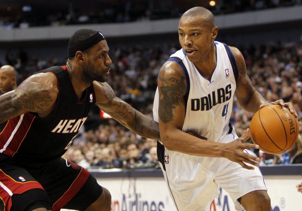 Dallas Mavericks Caron Butler (4) is defended by the Miami Heat's LeBron James (6) during...