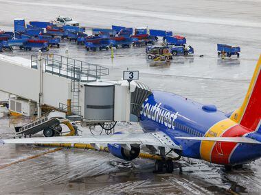 A plane with Southwest Airlines sits at one of the terminals at Dallas Love Field Airport in...