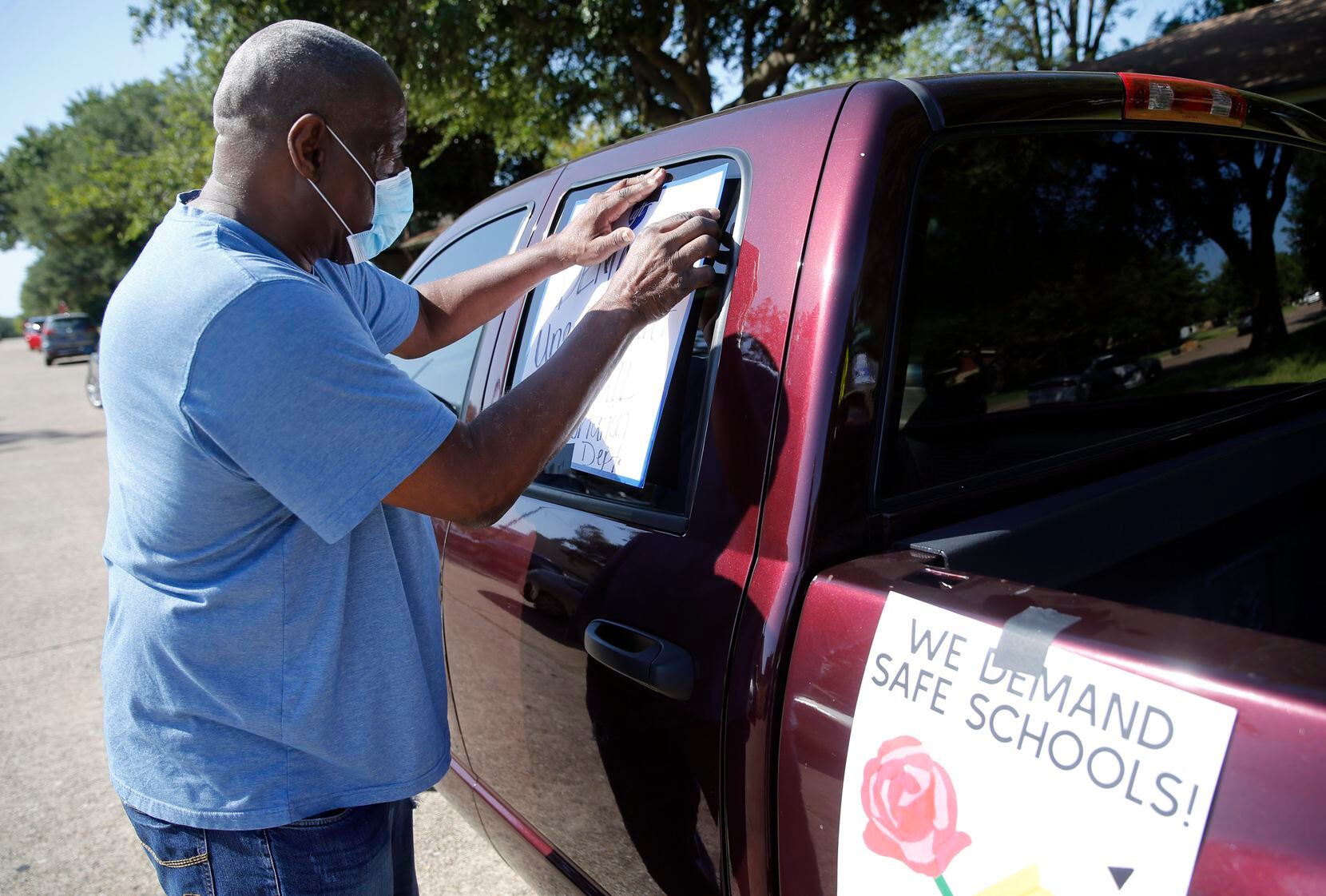 Leon Spikes, a DISD bus driver decorates his truck at Edna Rowe Elementary School in Dallas...