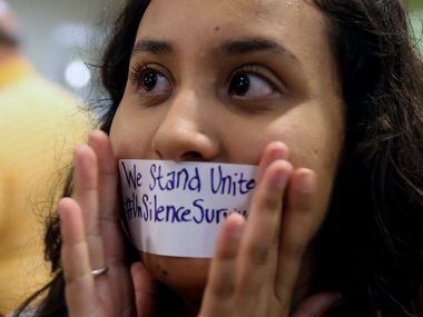 Baylor junior Julieth Reyes cover her mouth with tape during a rally against sexual assault...