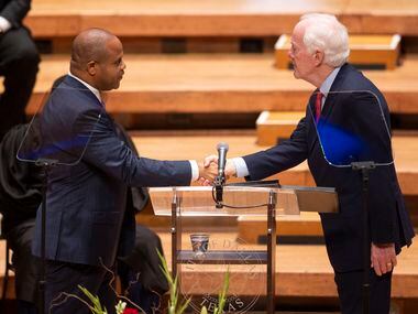 Dallas Mayor Eric Johnson shakes hands with U.S. Sen. John Cornyn after taking the oath of...