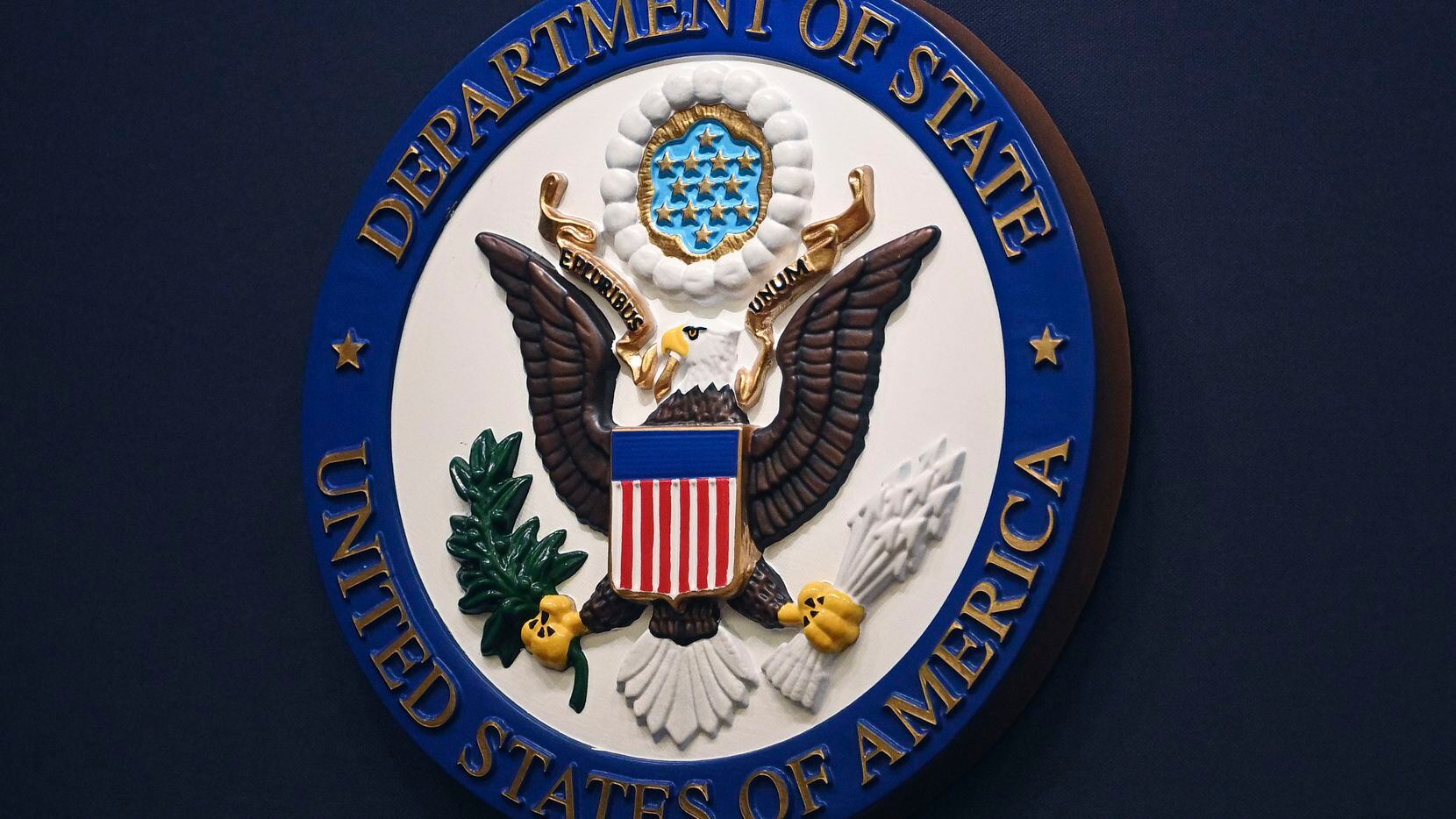 FILE - The State Department seal is seen on the briefing room lectern at the State...