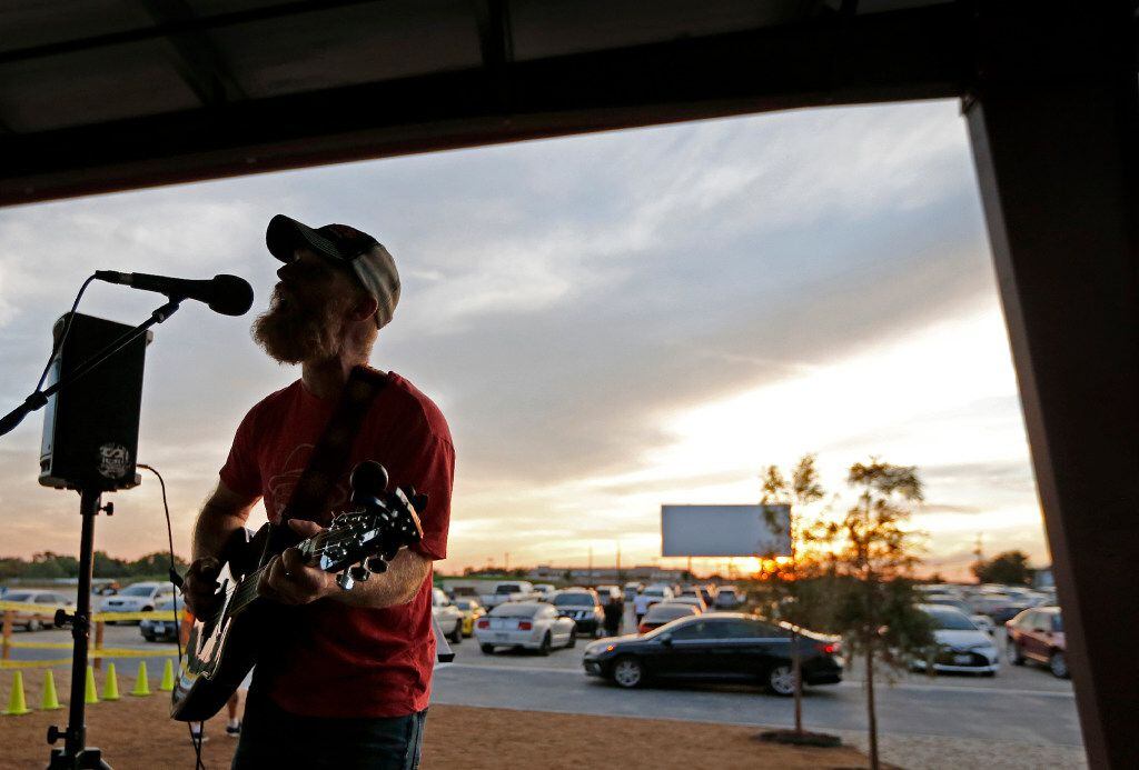 Joshua Irwin of Fort Worth entertains the crowd on the covered patio with some live music...