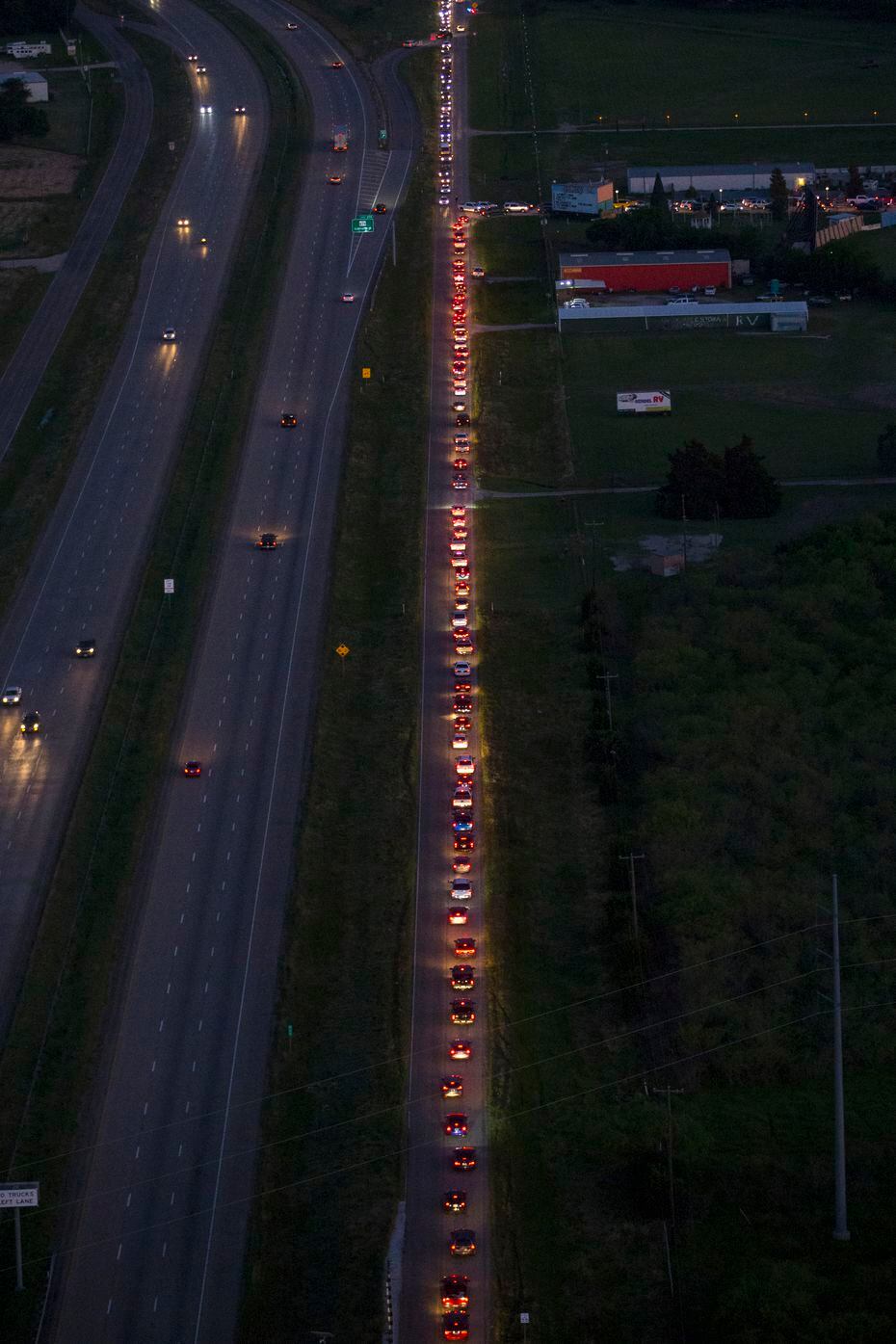 Cars line up to enter Galaxy Drive-In Movie Theatre is seen on Saturday, May 2, 2020 in Ennis, Texas. (Ryan Michalesko/Staff Photographer)