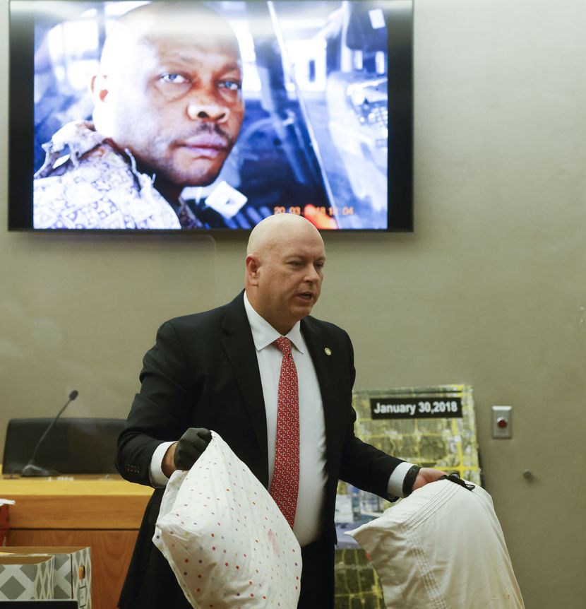 Prosecutor Glen Fitzmartin shows the pillows that were used to suffocate victims Mary Brooks...