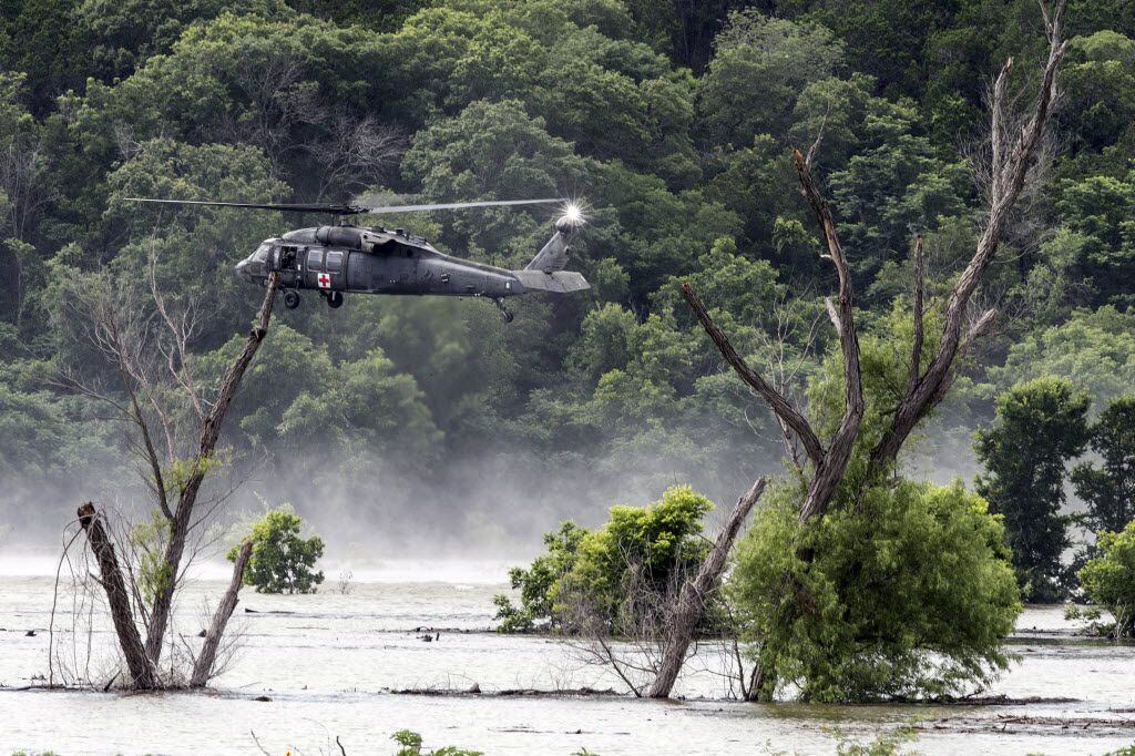 Army helicopters hover above Lake Belton on June 3, 2016, searching for four missing...