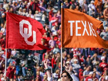 The Longhorn carries the flags of both schools before an NCAA football game between Texas and Oklahoma at the Cotton Bowl on Saturday, Oct. 12, 2019, in Dallas.