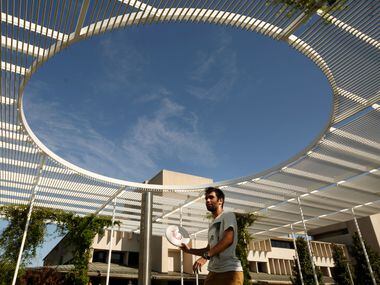 Daniel Barrios plays frisbee with other students near the student union on the campus of...