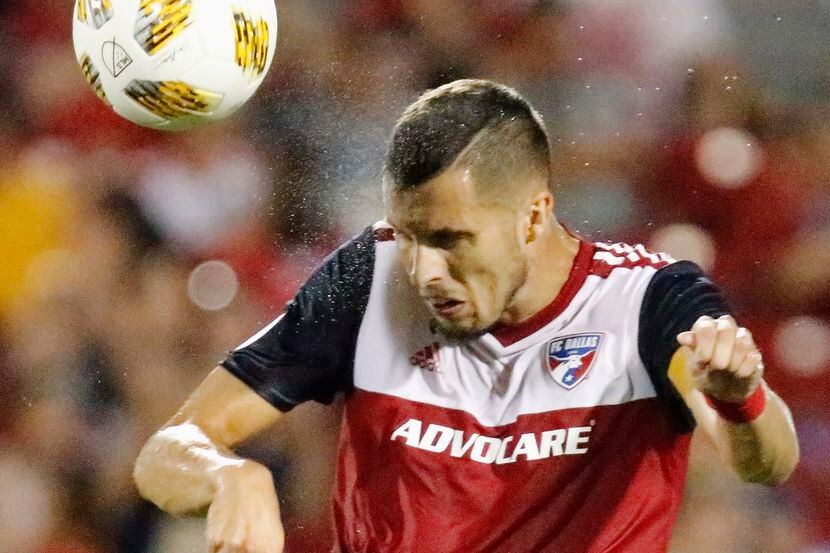 FC Dallas defender Matt Hedges (24) heads the soccer ball during the second half as FC...
