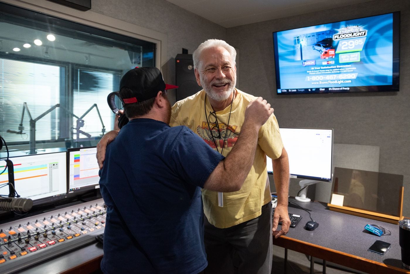 Radio legend Mike Rhyner reacts with excitement after hugging long time friend and producer...