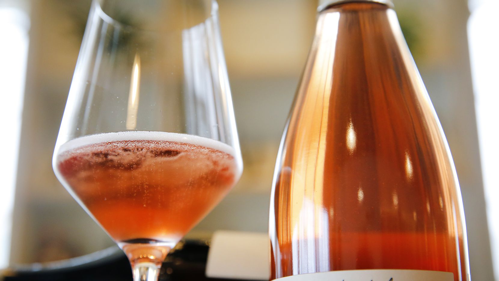 A glass of Les Capriades piege a filles rose rose is pictured at Bar and Garden on Ross Ave...