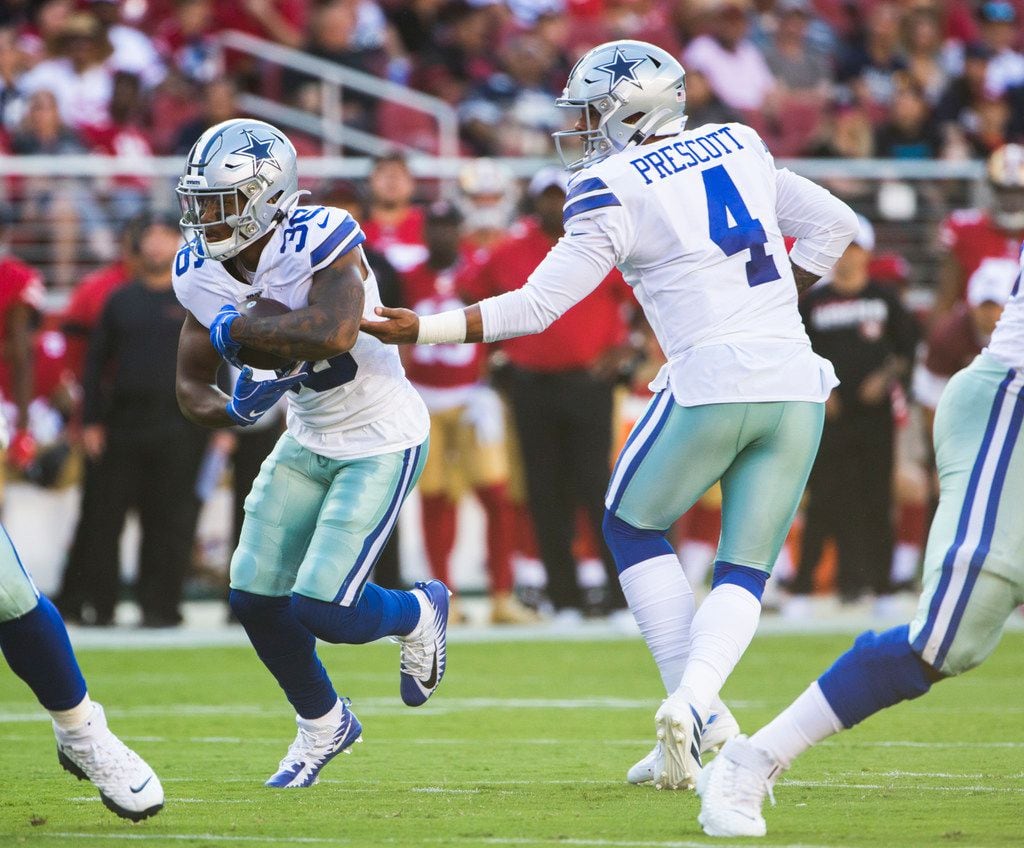Dallas Cowboys quarterback Dak Prescott (4) hands off the ball to running back Tony Pollard...