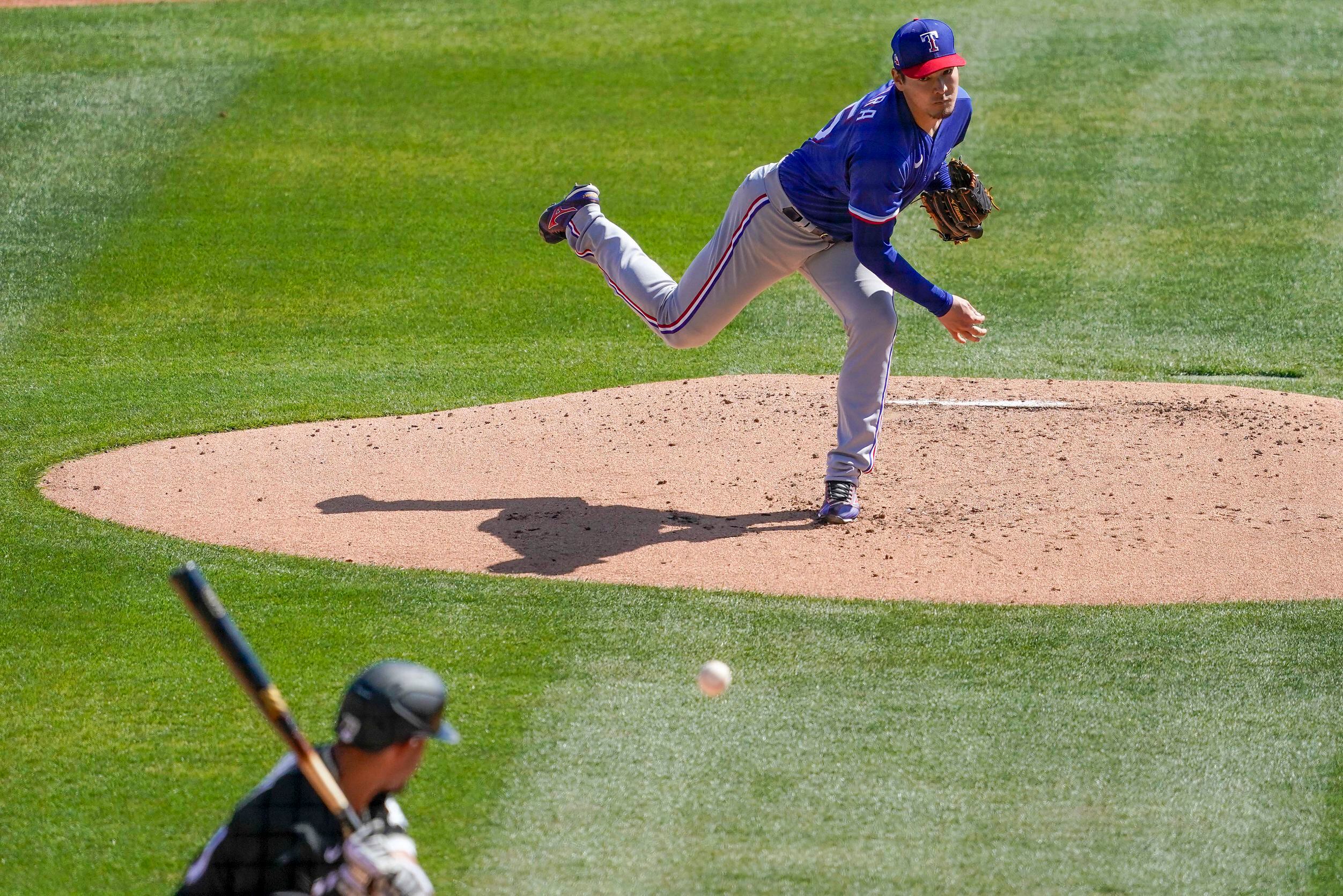 Texas Rangers third baseman Brock Holt (16) blows a bubble during a  baseball game against the