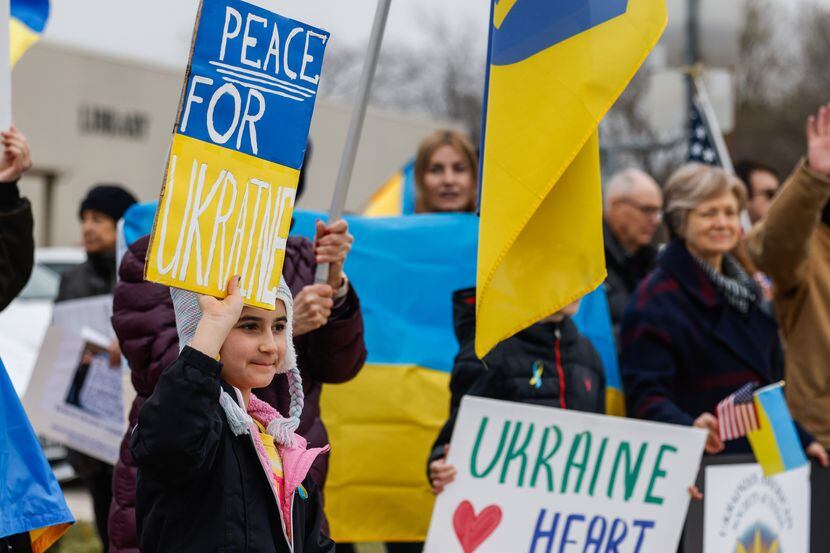 Viana Giordano, 10, shows support for the Ukrainian people during a rally in The Colony on...