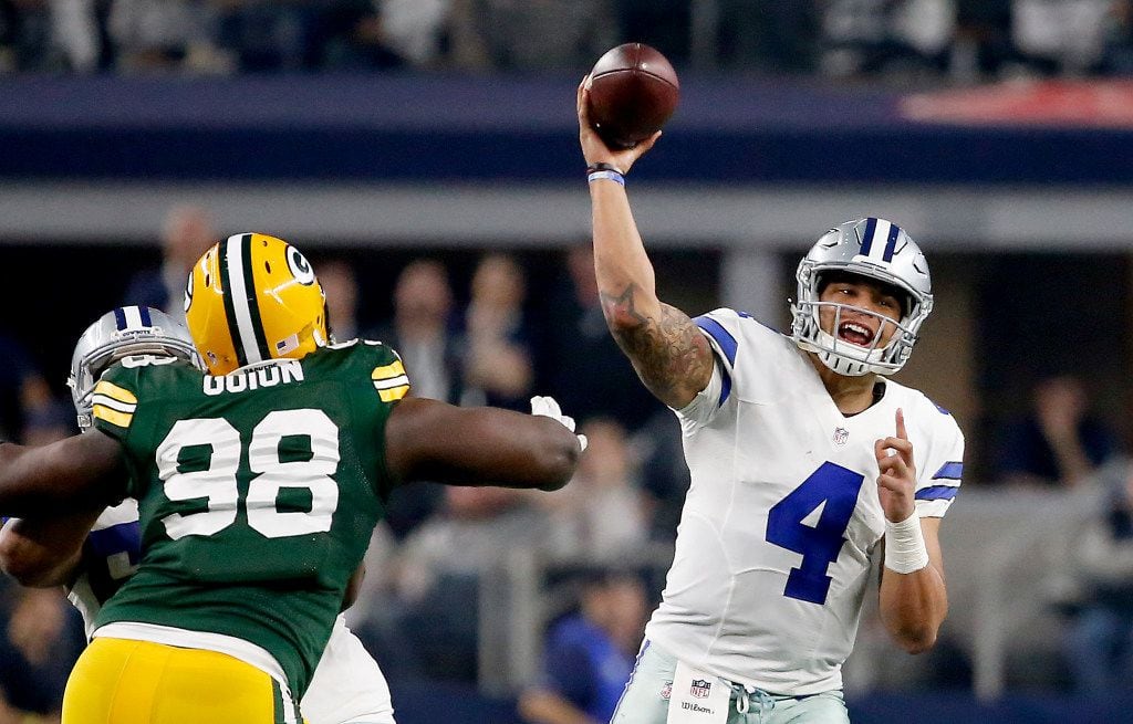 Dallas Cowboys quarterback Dak Prescott (4) throws the ball downfield over Green Bay Packers...
