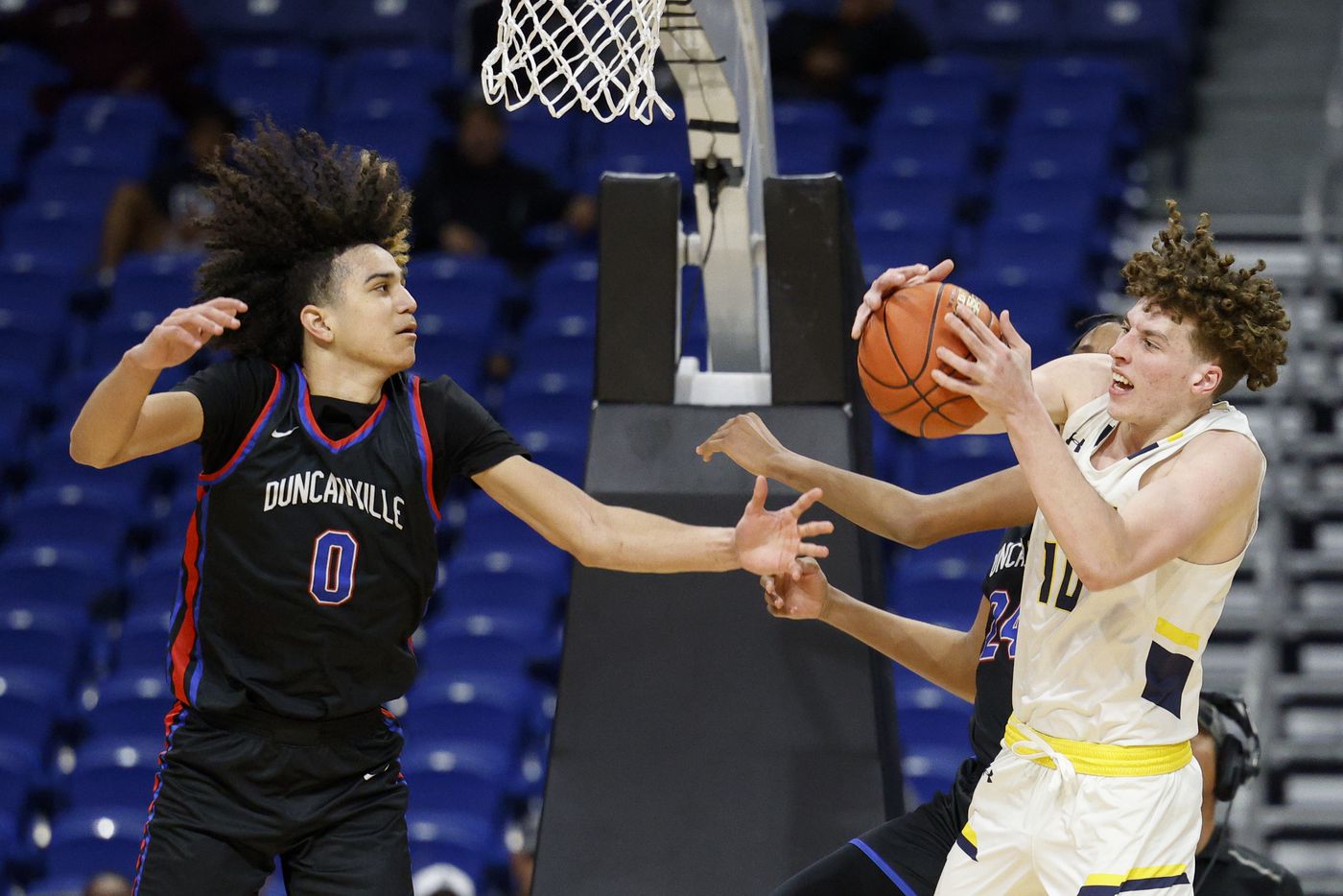McKinney forward Thatcher McClure (10) collects a rebound ahead of Duncanville guard Anthony...